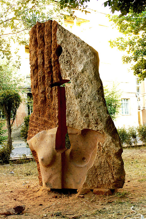 The sculptor Artem Medvedev. Contemporary sculpture. Apple of discord. Gyumri, Armenia. Three-quarter view. 2015, 202 x 120 x 50 cm, tufa granite